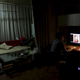 Wang Dong, a fan of online hostess Siqi, looks at a cartoon portrait of her, at home